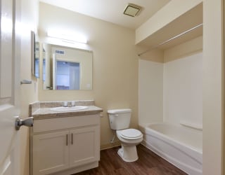 a bathroom with a sink toilet and a bath tub at Old Monterey Apartments, Springfield