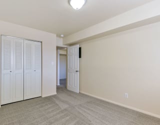 a living room with white doors and a door to a hallway at Old Monterey Apartments, Springfield