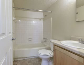 a bathroom with a sink toilet and a bath tub at Old Monterey Apartments, Springfield, MO, 65807