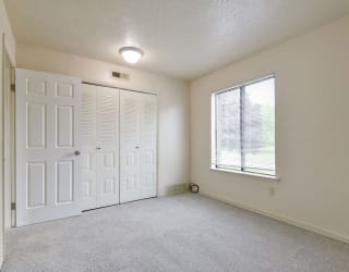 an empty room with a door and a window at Old Monterey Apartments, Springfield, MO, 65807