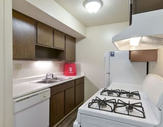 a kitchen with a stove and a sink and a refrigerator at Old Monterey Apartments, Springfield