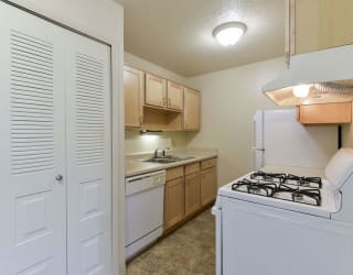 a kitchen with a stove and a refrigerator at Old Monterey Apartments, Springfield