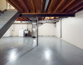 a large garage with a steel floor and stairs at Mount Royal Townhomes, Michigan, 49009