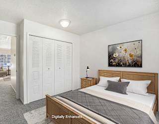 a bedroom with a large closet at Newport Village Apartments, Portage, MI