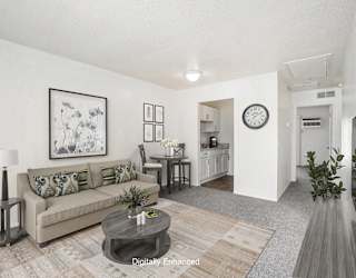 living and dining rooms to a kitchen with hard surface flooring at Newport Village Apartments, Portage, MI