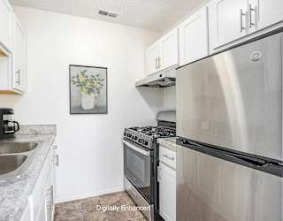 A kitchen with a stainless steel appliances at Newport Village Apartments, Portage, MI