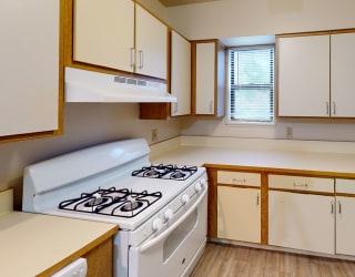 an empty kitchen with a stove and refrigerator at North Pointe Apartments, Elkhart, IN