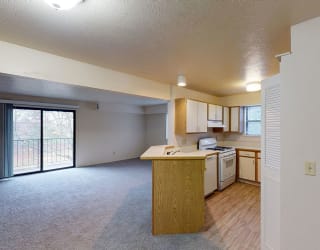 a kitchen with an island in the middle of a living roomat North Pointe Apartments, Elkhart, IN