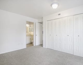 master bedroom with a large closet and a bathroom at North Pointe Apartments in Elkhart, IN