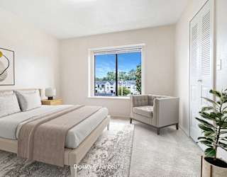 A bedroom with a large bed and a window at North Pointe Apartments, Elkhart