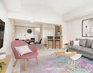 A living room with a grey couch and plush carpeting at North Pointe Apartments, Elkhart
