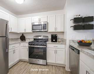 upgraded kitchen with stainless steel appliances and white cabinets at North Pointe Apartments, Indiana, 46514