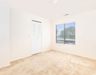 an empty room with a window and a door  at Oak Shores Apartments, Oak Creek, 53154