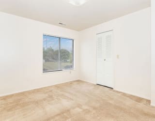 an empty room with a window and a door  at Oak Shores Apartments, Oak Creek, 53154