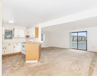 an empty room with a kitchen and a window  at Oak Shores Apartments, Oak Creek, 53154