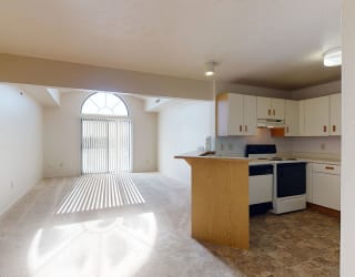 an empty kitchen with an island in the middle  at Oak Shores Apartments, Oak Creek, 53154