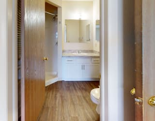 a bathroom with a toilet and a sink  at Oak Shores Apartments, Oak Creek, Wisconsin