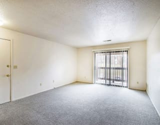 living room with access to private balcony at Seville Apartments, Kalamazoo, MI, 49009