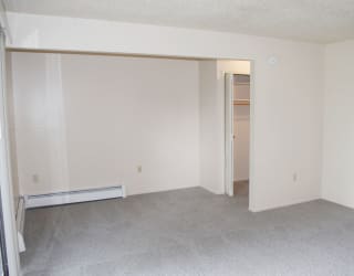 living and dining areas with a closet at Seville Apartments, Kalamazoo, 49009