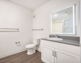 a bathroom with hard-surface flooring and a lighted mirror  at Signature Pointe Apartment Homes, Athens, AL, 35611