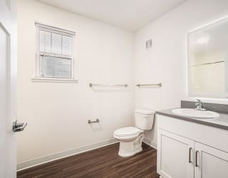 a bathroom with a window and a lighted mirror  at Signature Pointe Apartment Homes, Athens, AL