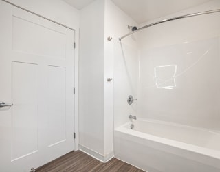 a bathroom with a shower and a tub at Signature Pointe Apartment Homes, Athens, Alabama