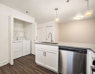 a kitchen with a full-size washer and dryer  at Signature Pointe Apartment Homes, Athens, 35611