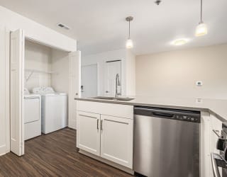 a kitchen with a full-size washer and dryer  at Signature Pointe Apartment Homes, Athens, AL, 35611
