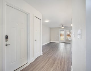 Entry hallway with wood floors leading to living room  at Signature Pointe Apartment Homes, Athens, 35611