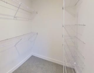 walk in closet with wardrobe organizers at Signature Pointe Apartment Homes in Athens, AL