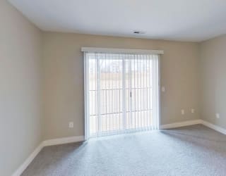 living room with a slider to a private balcony at Signature Pointe Apartment Homes in Athens, AL