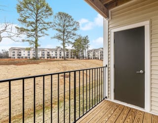 Private balcony with enclosed storage overlooking apartment community  at Signature Pointe Apartment Homes, Athens, AL, 35611