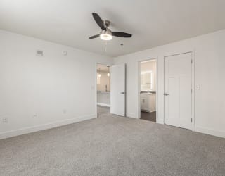 Bedroom with a ceiling fan and doors to a 2nd bathroom and closet  at Signature Pointe Apartment Homes, Athens, 35611