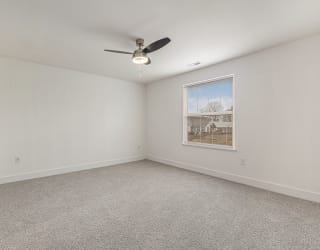 Large bedroom with a ceiling fan and a window  at Signature Pointe Apartment Homes, Athens