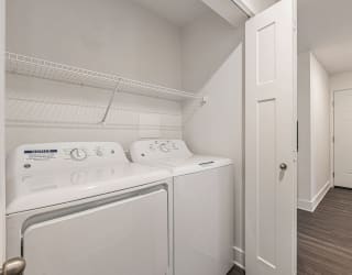 a washer and dryer in a laundry room  at Signature Pointe Apartment Homes, Athens, 35611
