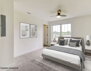 a bedroom with a bed and a ceiling fan  at Signature Pointe Apartment Homes, Athens, AL, 35611