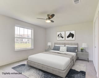 a bedroom with a bed and a ceiling fan  at Signature Pointe Apartment Homes, Athens, Alabama