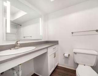 a bathroom with a sink toilet and a mirror at Stoney Pointe Apartment Homes, Kansas, 67226