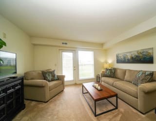a living room with two couches and a coffee table at Stoney Pointe Apartment Homes, Kansas