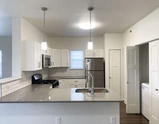 a kitchen with a window and washer and dryer at Stoney Pointe Apartment Homes, Wichita, KS