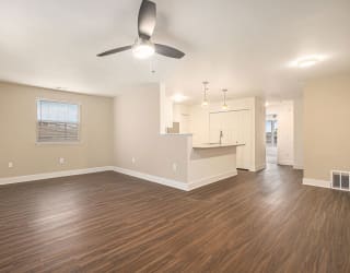 end style living room with a ceiling fan and hard surface floors at Stoney Pointe Apartment Homes, Wichita