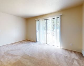an empty room with white walls and a window at Swiss Valley Apartments, Wyoming, 49509