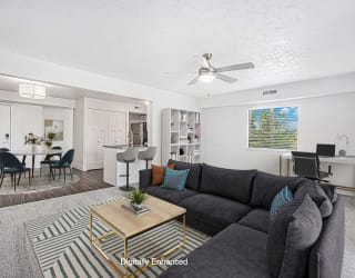 enlarged living room with a ceiling fan at The Crossings Apartments, Michigan, 49508