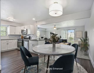 an open kitchen and dining room with a table and chairs at The Crossings Apartments in Grand Rapids, MI