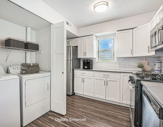 kitchen with a washer and dryer and a window at The Crossings Apartments, Michigan, 49508