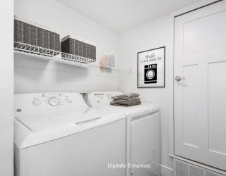 laundry room with a washer and dryer at The Crossings Apartments, Michigan, 49508