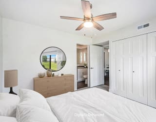 a bedroom with a ceiling fan at The Crossings Apartments, Michigan, 49508