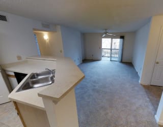A kitchen area with a sink and a window.