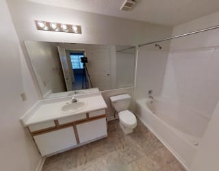 A bathroom with a sink, toilet, and bathtub.