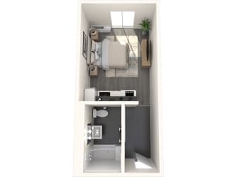 a bedroom with a bed and a desk in a small room